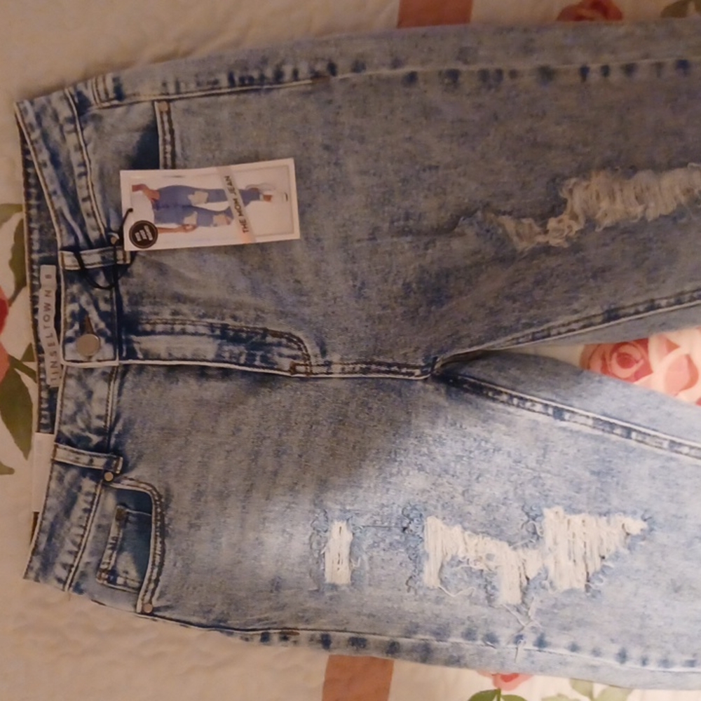 Brand new blue jeans still have tags